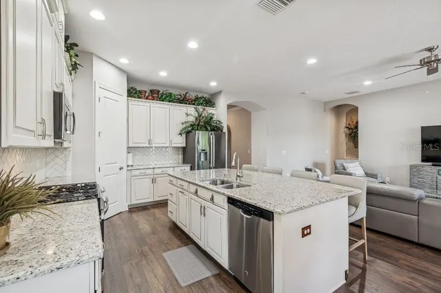 a kitchen with stainless steel appliances granite countertop a stove and a sink