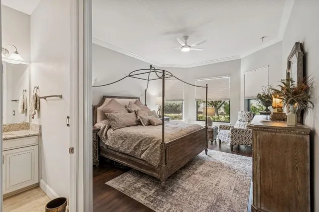 a bedroom with a large bed and a flat tv screen on dresser