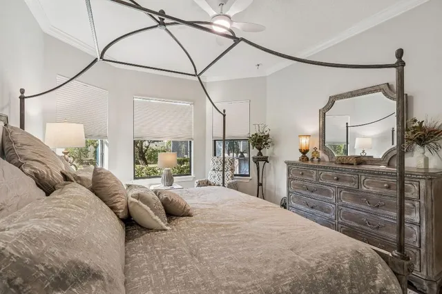 a bedroom with a large bed and a flat tv screen on the dresser