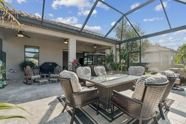a view of a patio with table and chairs under an umbrella