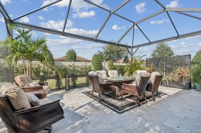 a view of a patio with table and chairs under an umbrella