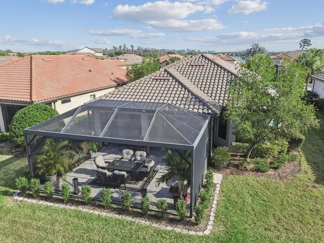 an aerial view of a house with a yard and potted plants