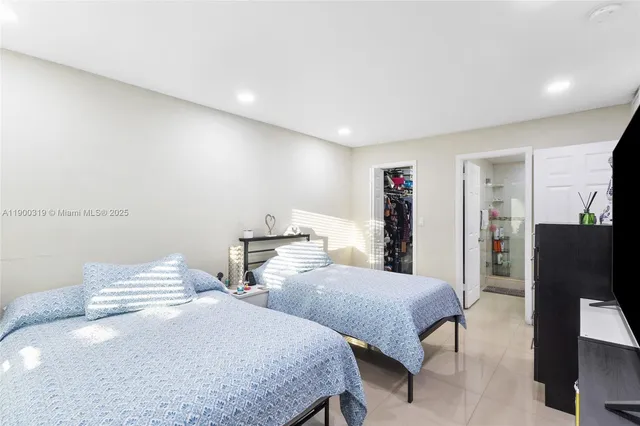 a bedroom with two beds and painted walls