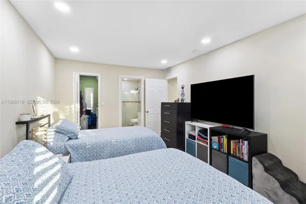 a bedroom with a bed and a flat screen tv