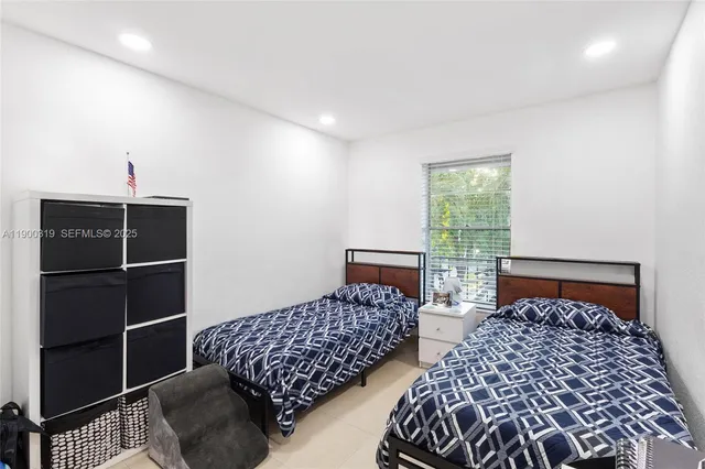 a bedroom with bed and a window