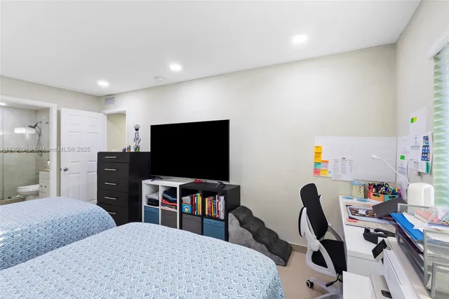 a view of a livingroom with workspace and a couch