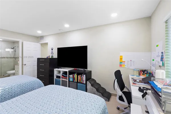 a view of a livingroom with workspace and a couch