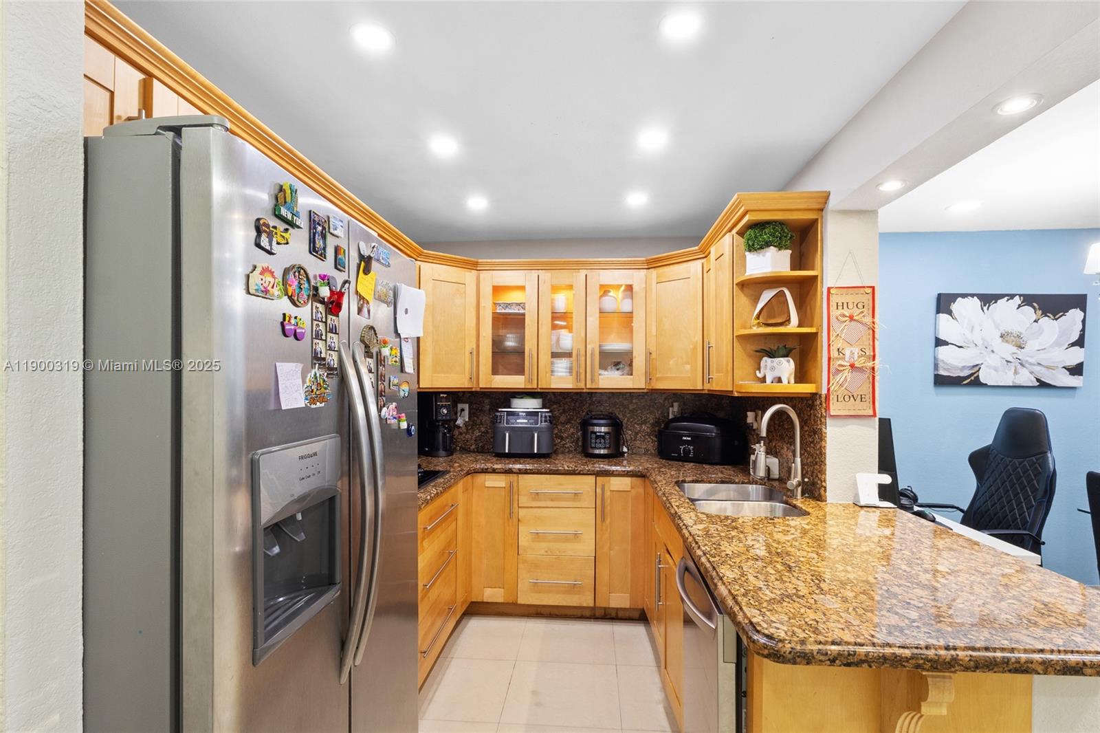 5665 West 20th Avenue, Unit 212 Hialeah, FL 33012 - Photo 8 of 38 a view of a kitchen with a sink and refrigerator