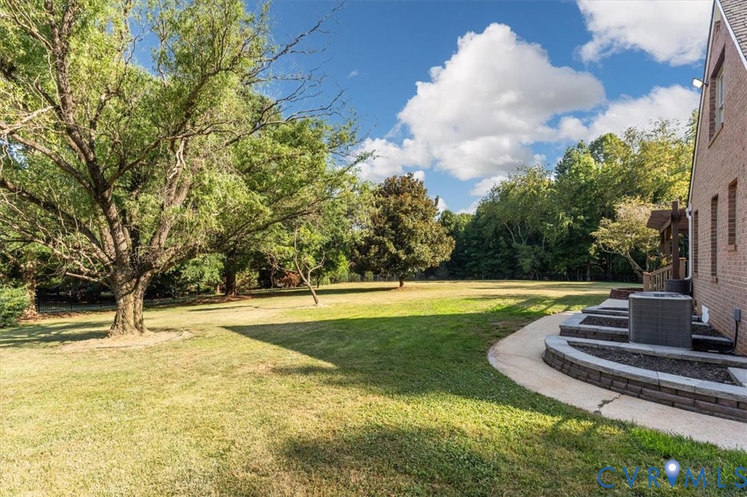 1437 Palmore Road Powhatan, VA 23139 - Photo 53 of 60 Expansive lawn area with mature trees and a curved