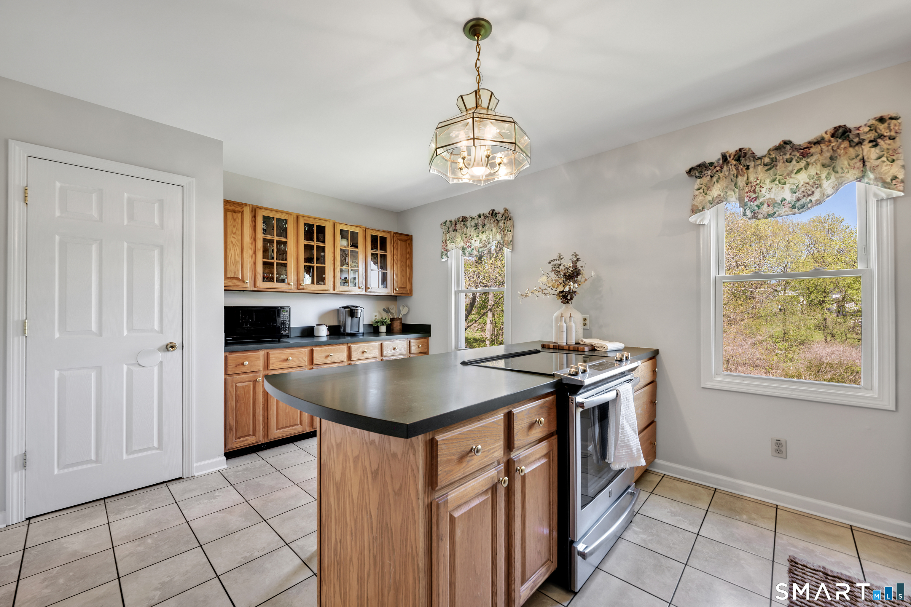 28 Maple Street Torrington, CT 06790 - Photo 11 of 23 a kitchen with stainless steel appliances granite countertop a stove and a refrigerator
