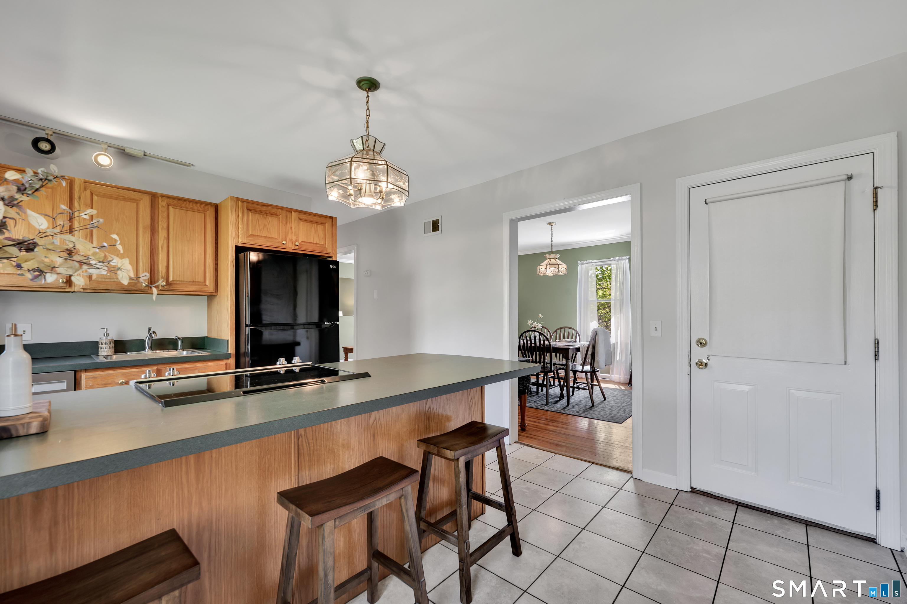 28 Maple Street Torrington, CT 06790 - Photo 12 of 23 a room with stainless steel appliances a table and chairs in it