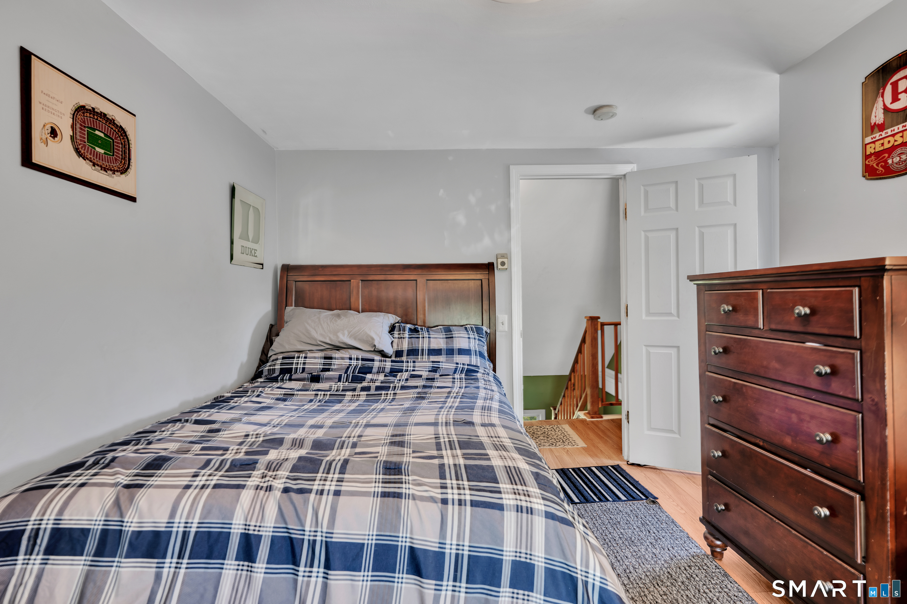 28 Maple Street Torrington, CT 06790 - Photo 15 of 23 a bedroom with a bed and wooden floor