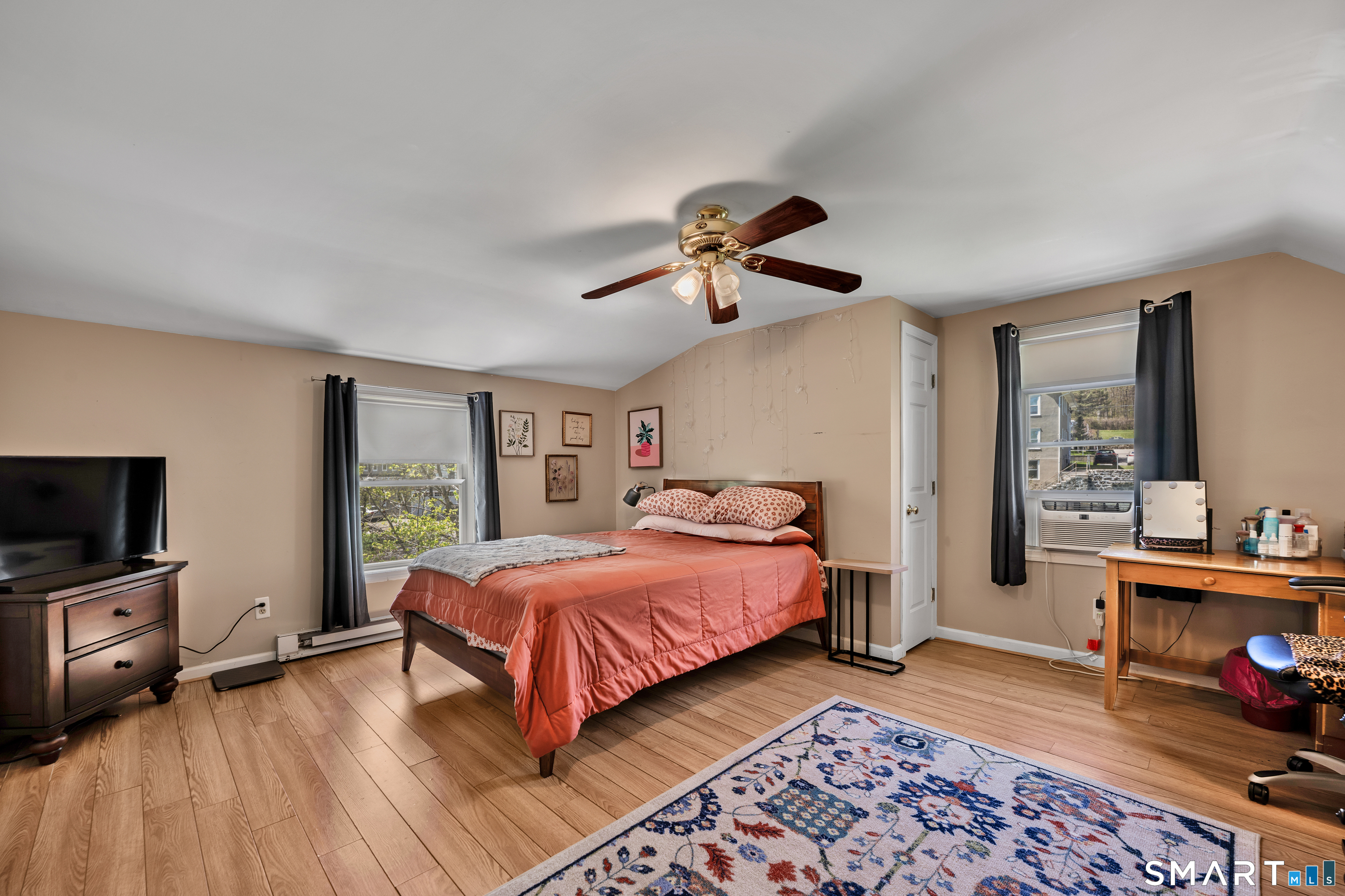 28 Maple Street Torrington, CT 06790 - Photo 16 of 23 a bedroom with a bed and a chandelier