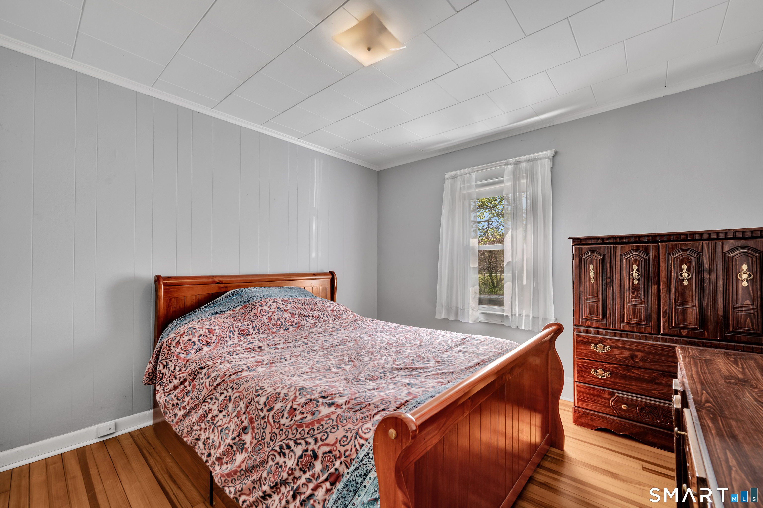 28 Maple Street Torrington, CT 06790 - Photo 22 of 23 a bedroom with a bed and wooden floor
