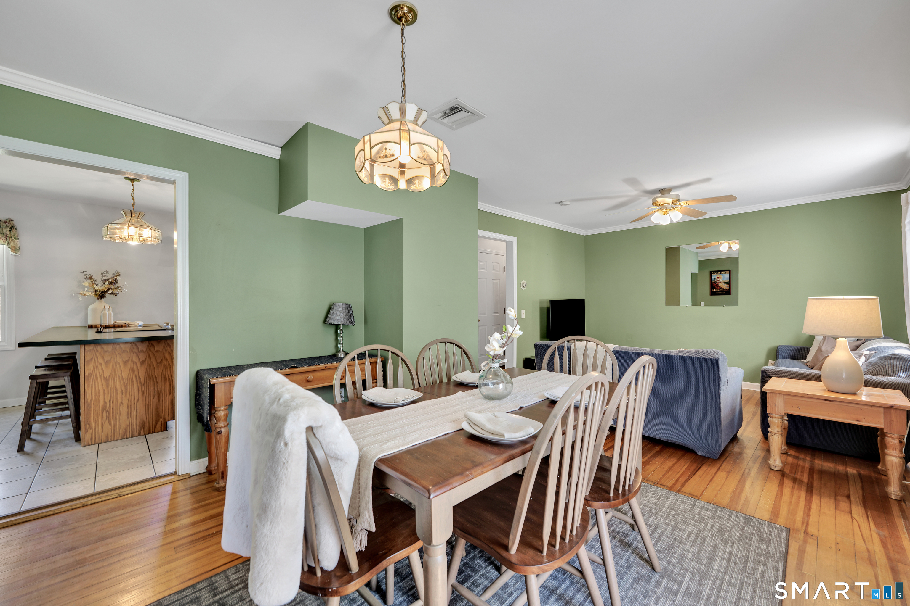 28 Maple Street Torrington, CT 06790 - Photo 8 of 23 a view of a dining room with furniture a chandelier and wooden floor