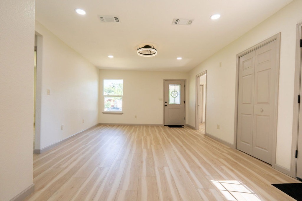 58 Hybiscus Court Lake Jackson, TX 77566 - Photo 2 of 21 a view of an empty room with wooden floor and a window