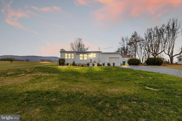 a aerial view of a house with a yard and lake view