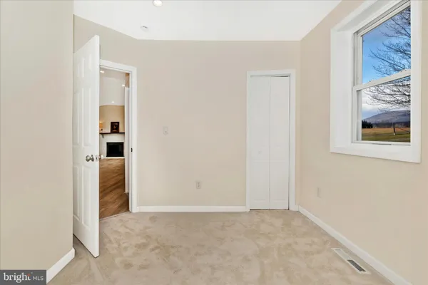 a view of empty room with wooden ceiling