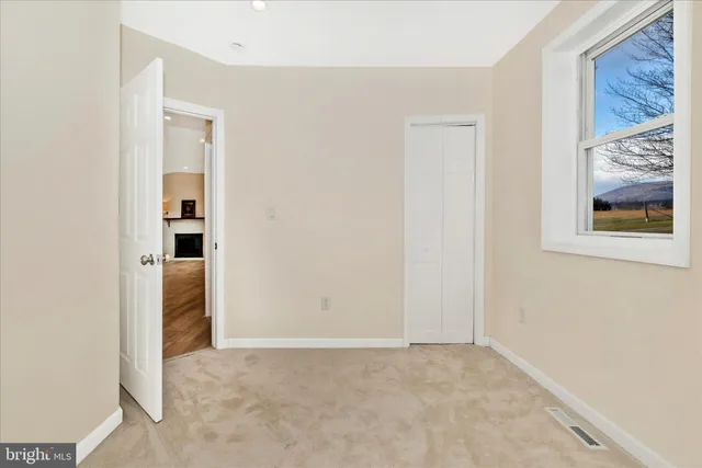 a view of empty room with wooden ceiling