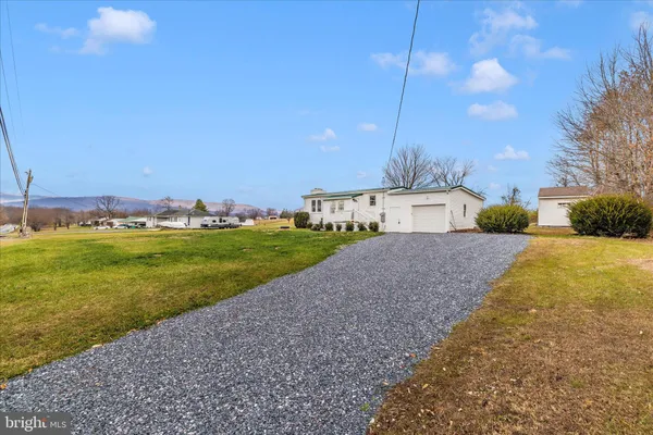 a view of yard covered with snow in front of house