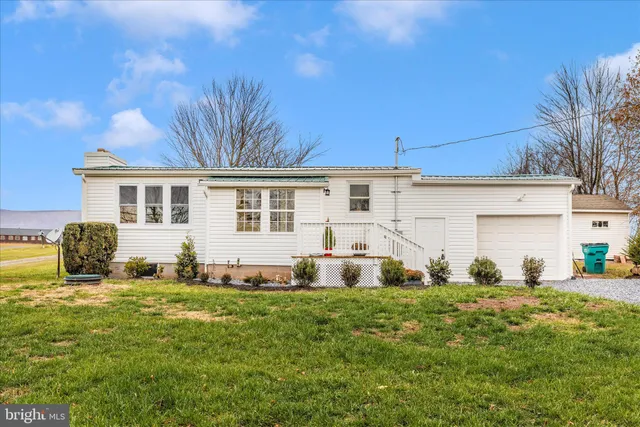 hallway with wooden floor and windows