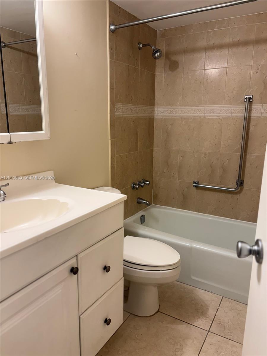 8335 Southwest 72nd Avenue, Unit 108D Miami, FL 33143 - Photo 12 of 20 a bathroom with a sink toilet and shower