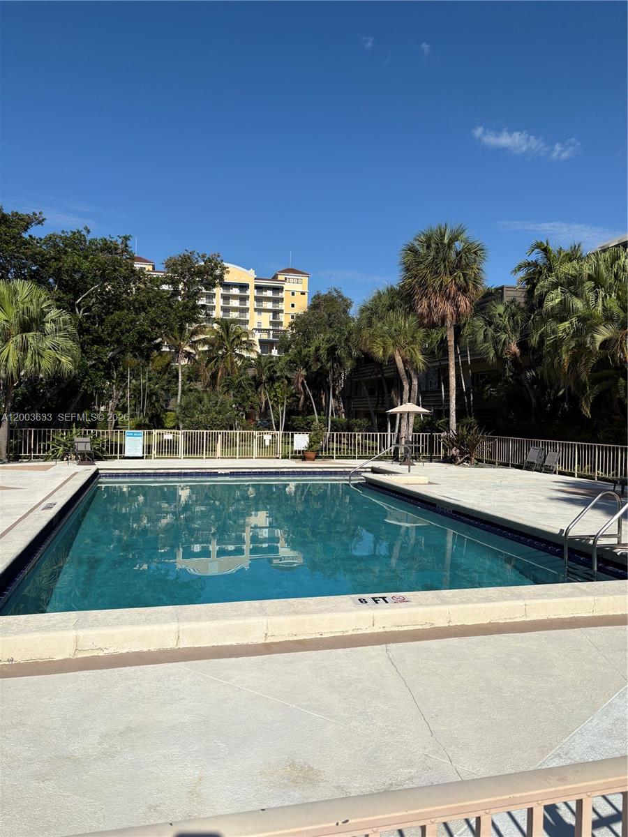 8335 Southwest 72nd Avenue, Unit 108D Miami, FL 33143 - Photo 17 of 20 a view of swimming pool with outdoor seating and yard