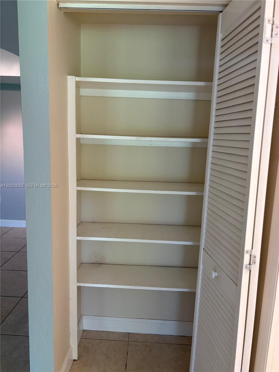8335 Southwest 72nd Avenue, Unit 108D Miami, FL 33143 - Photo 10 of 20 a view of walk in closet with empty racks