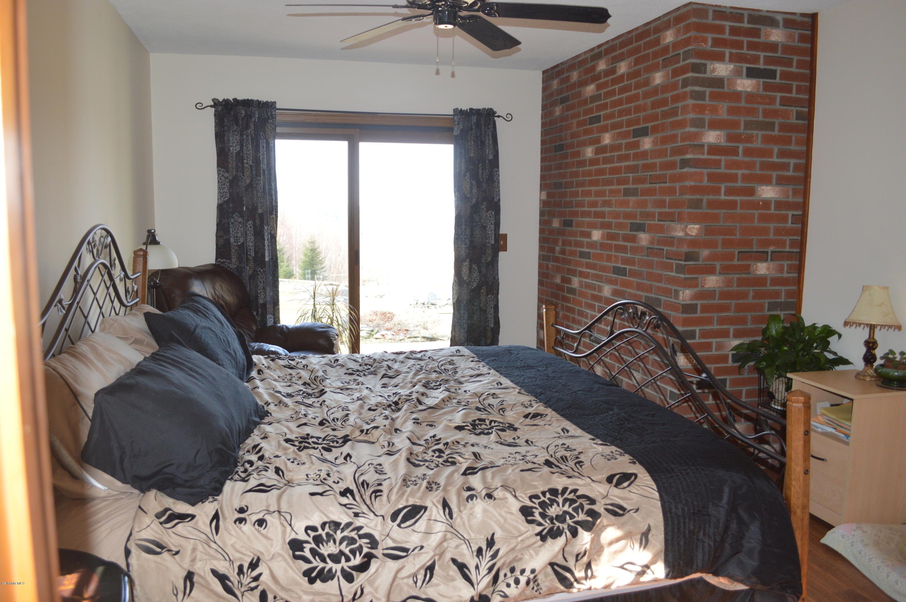 759 George Carter Road Becket, MA 01223 - Photo 12 of 56 a bed sitting in a bedroom next to a window