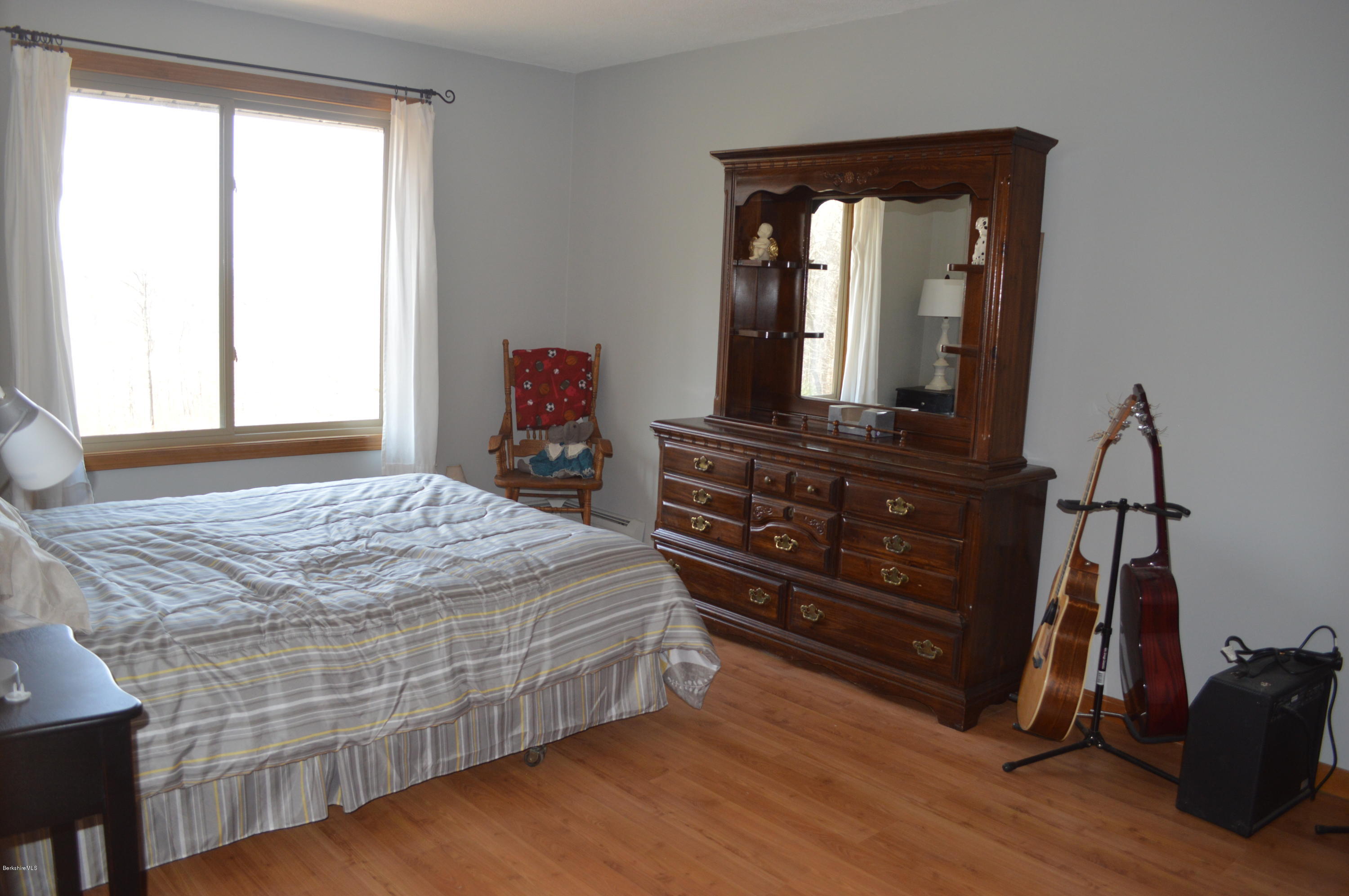 759 George Carter Road Becket, MA 01223 - Photo 17 of 56 a bedroom with a bed and a mirror on dresser