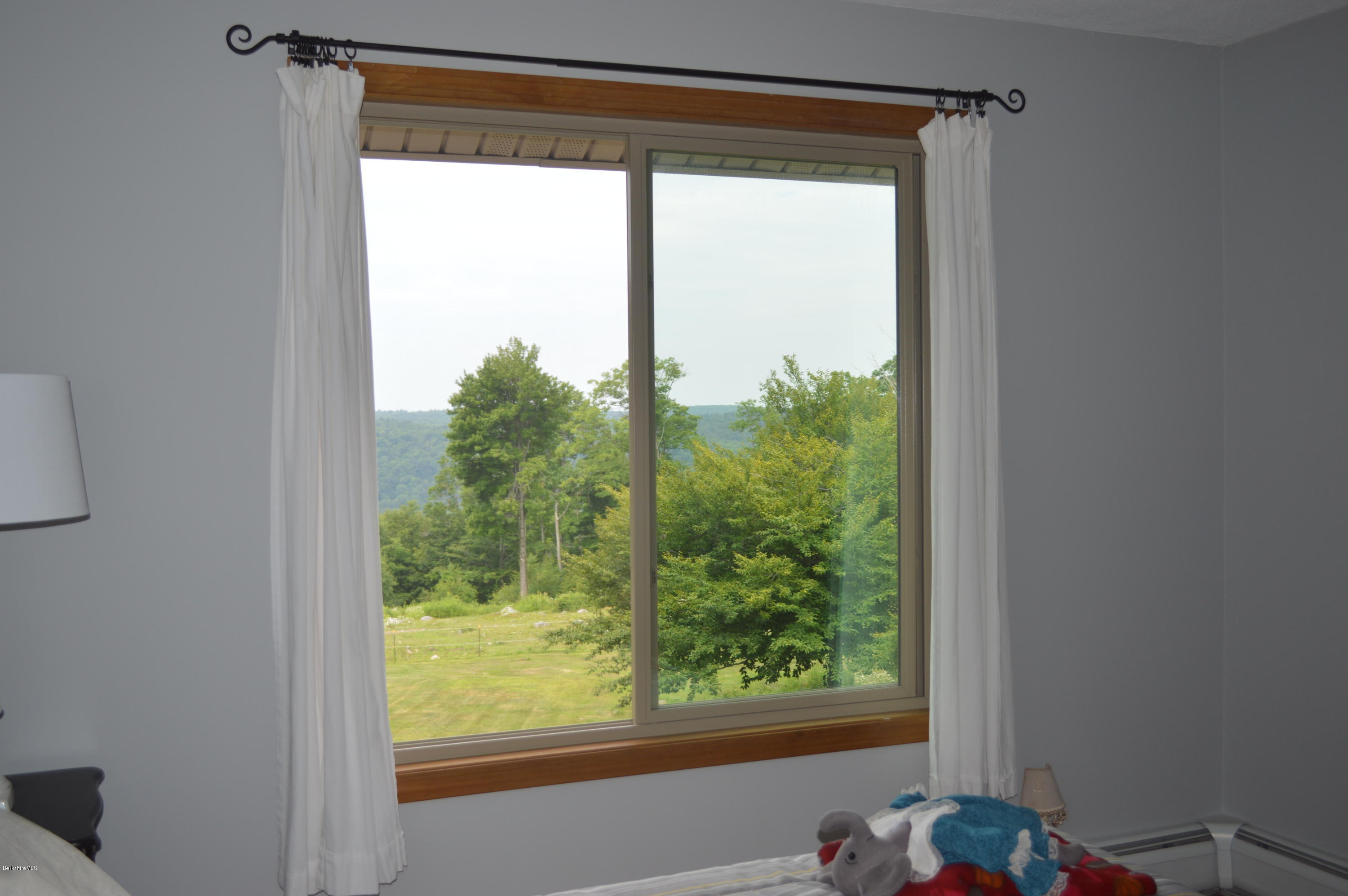 759 George Carter Road Becket, MA 01223 - Photo 37 of 56 a view of a room that has a window and a bed