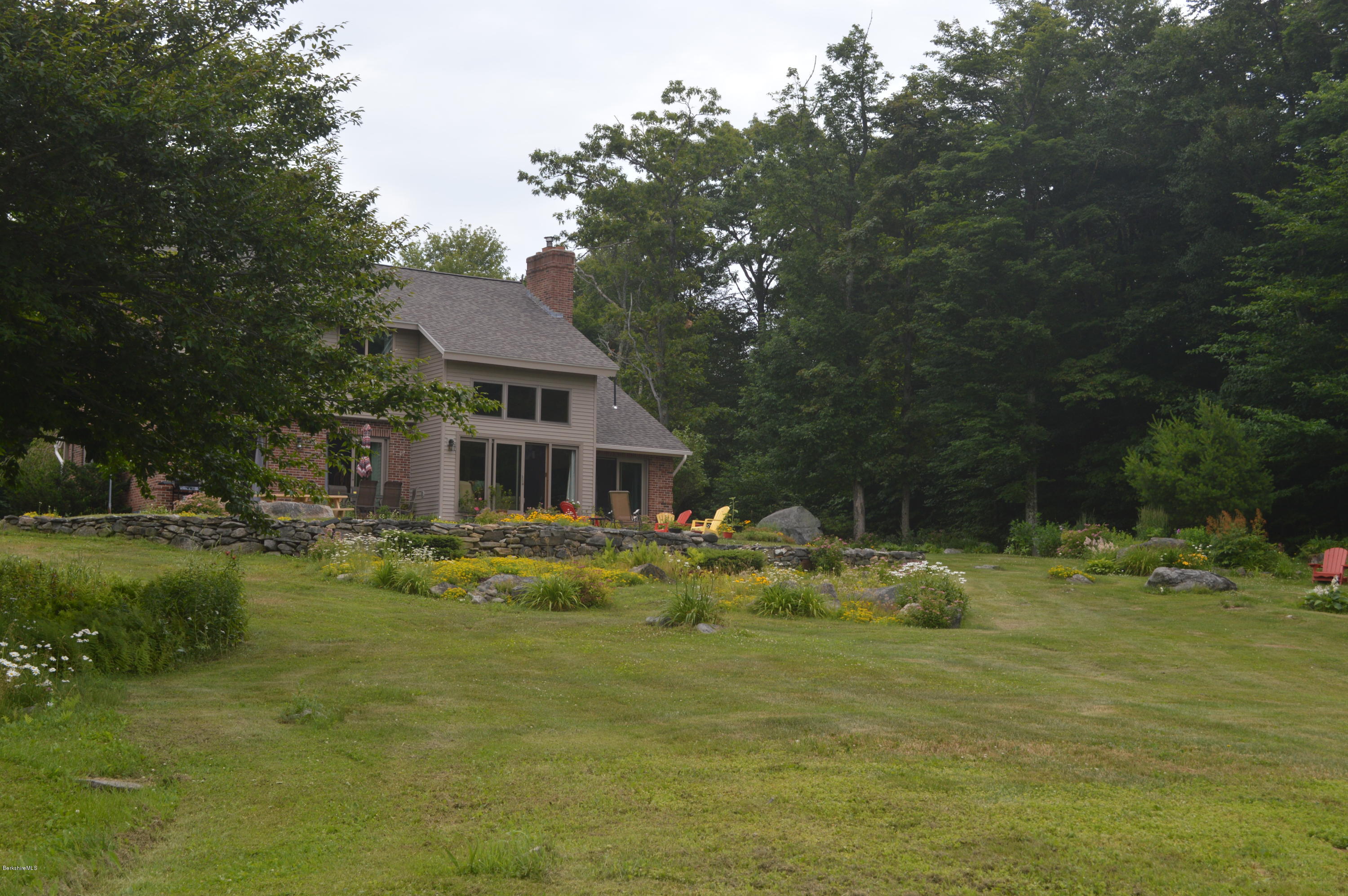 759 George Carter Road Becket, MA 01223 - Photo 49 of 56 a view of a house with a yard