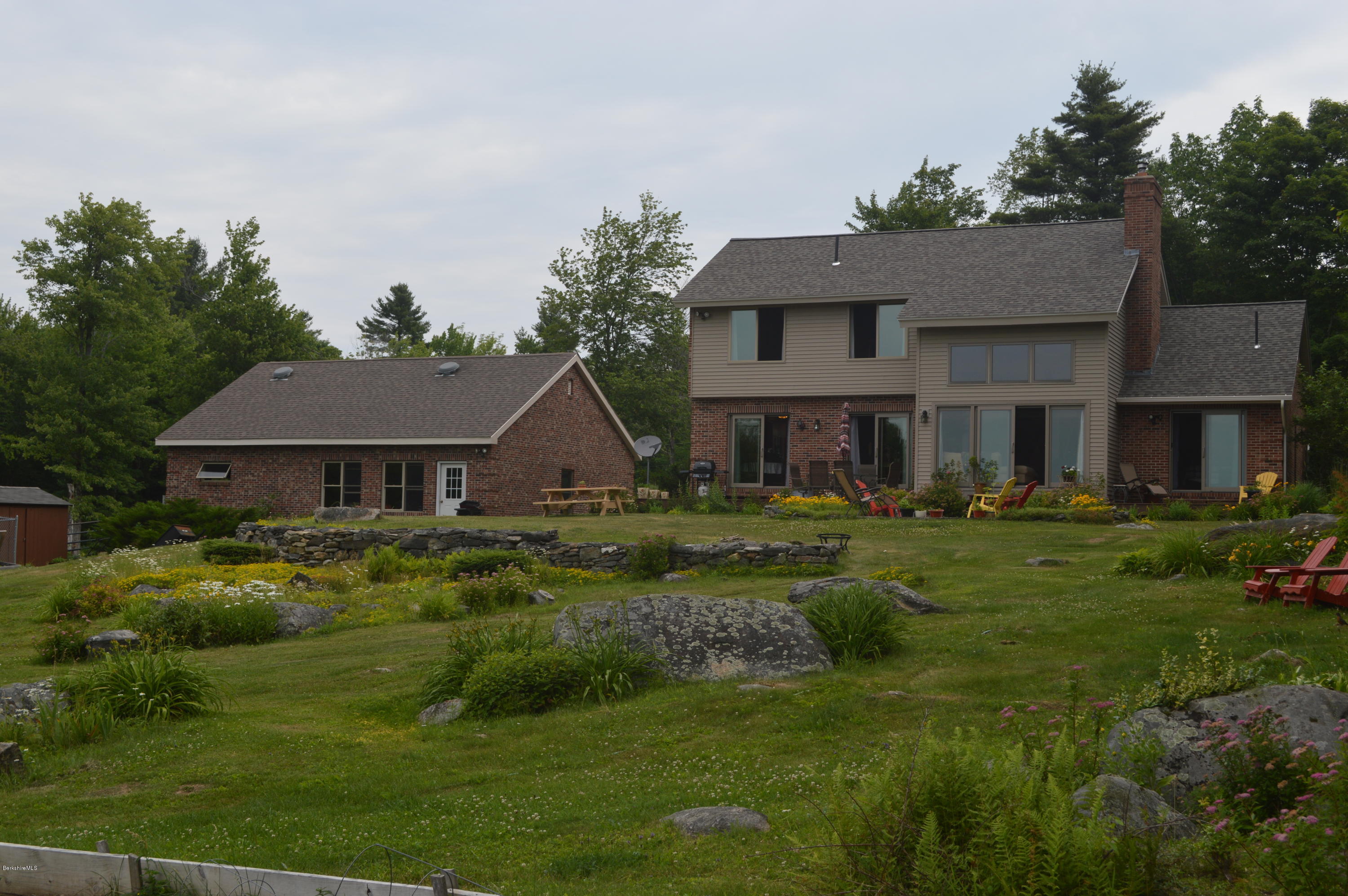 759 George Carter Road Becket, MA 01223 - Photo 50 of 56 a front view of a house with a garden