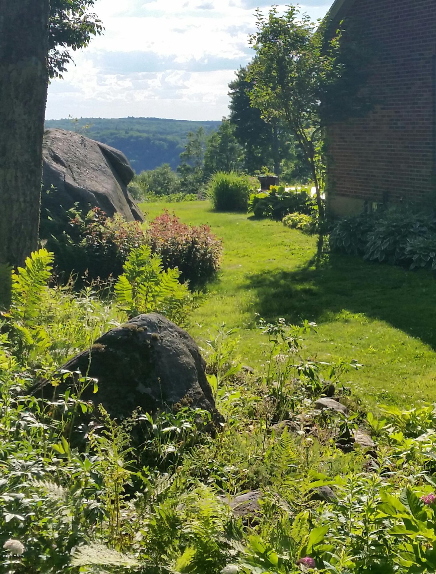 759 George Carter Road Becket, MA 01223 - Photo 54 of 56 a view of a garden with a lake