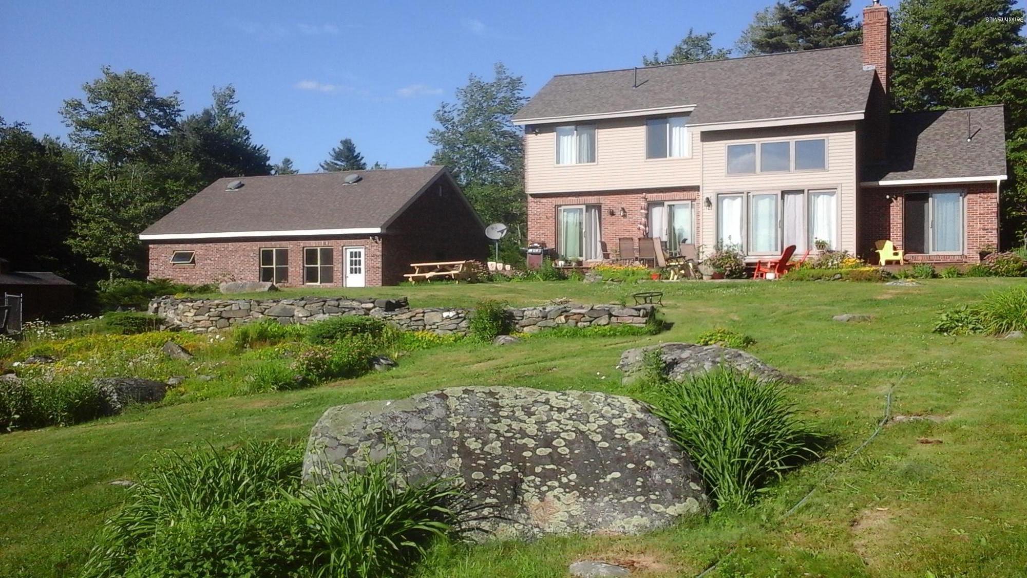 759 George Carter Road Becket, MA 01223 - Photo 55 of 56 a front view of a house with a yard