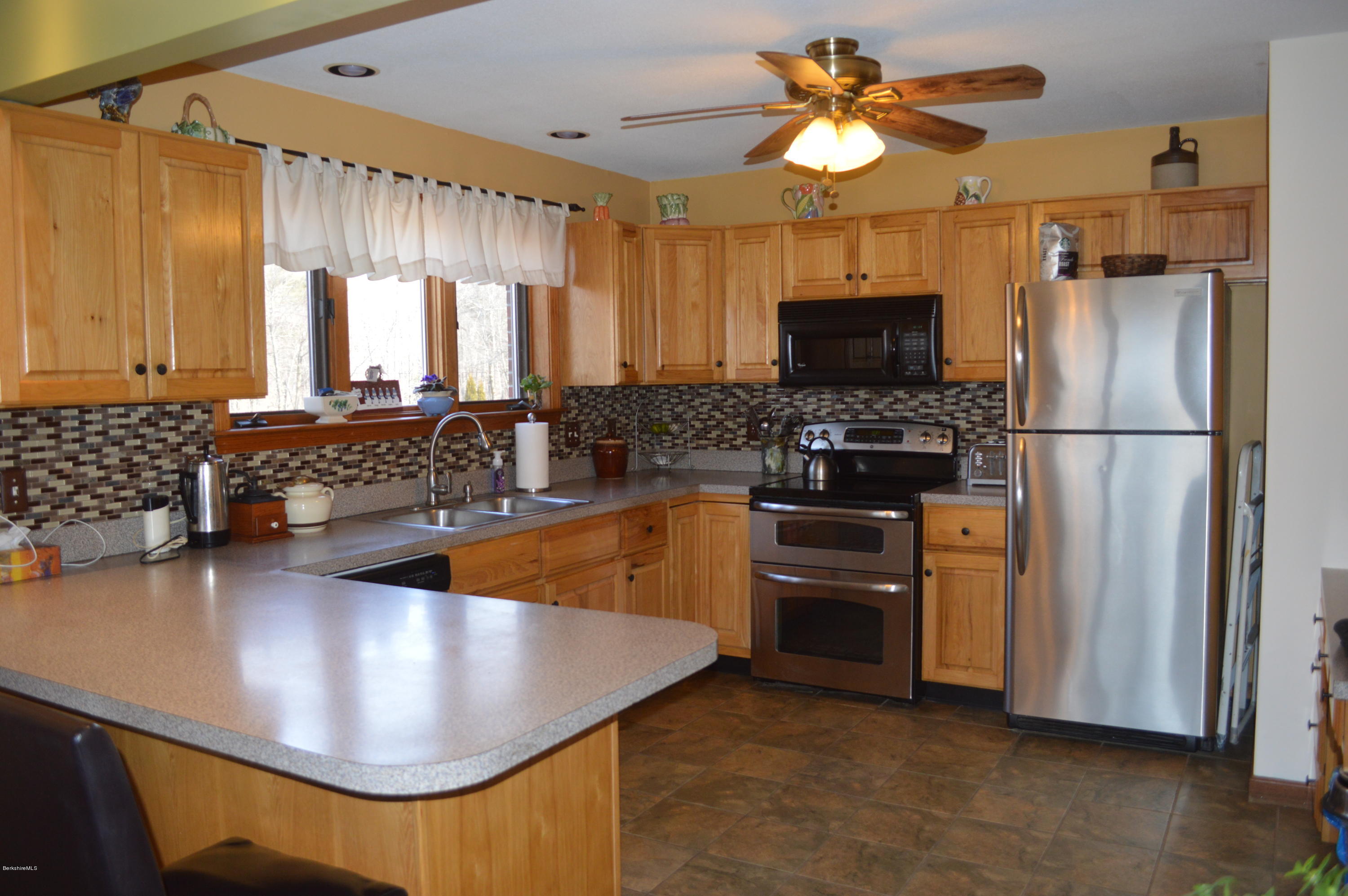 759 George Carter Road Becket, MA 01223 - Photo 9 of 56 a kitchen with stainless steel appliances granite countertop a stove a refrigerator and a sink