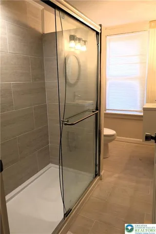 a bathroom with a glass shower door