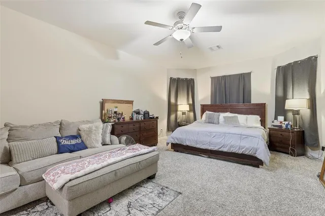 a bedroom with a large bed and a chandelier