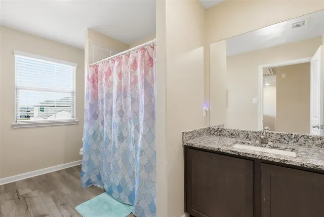 a view of a livingroom with stairs and an empty room