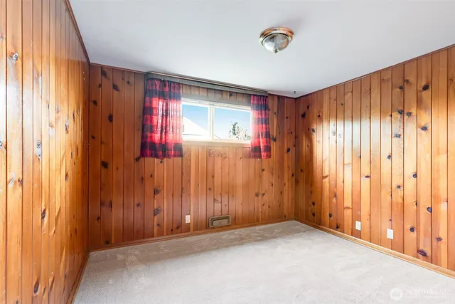 a bedroom with a large bed and a potted plant