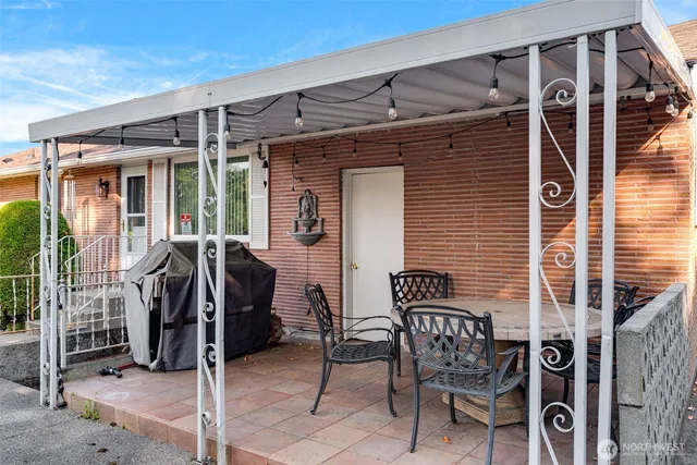 a view of a house with backyard sitting area and garden