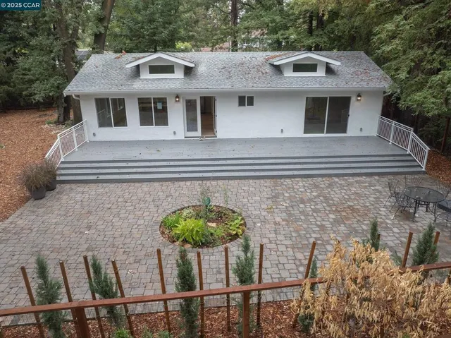 a front view of a house with plants