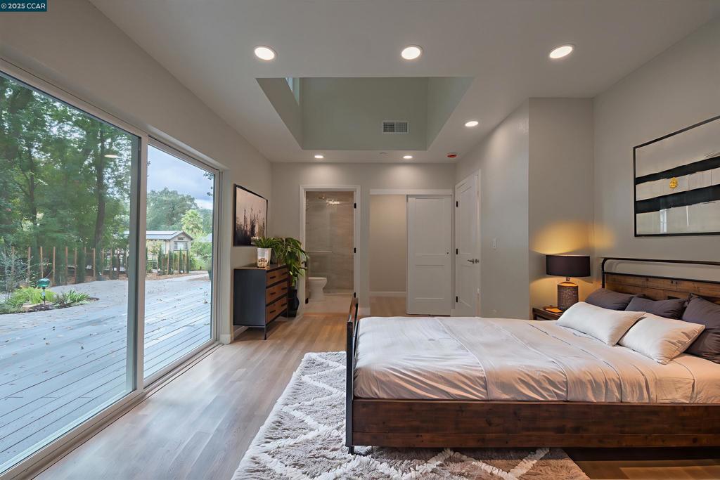 1244 Stone Valley Road Alamo, CA 94507 - Photo 13 of 20 a large bedroom with a bed and wooden floor