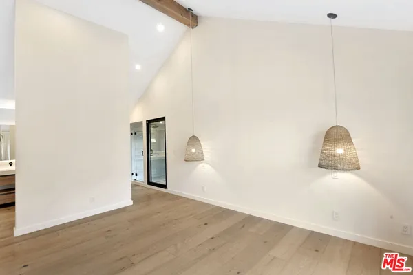 a living room with a flat screen tv and white walls