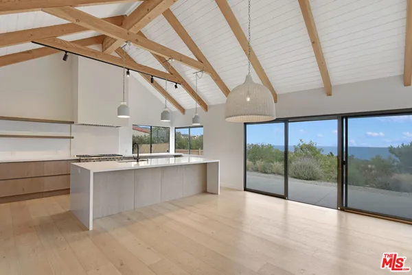 a view of a kitchen with a sink and a window