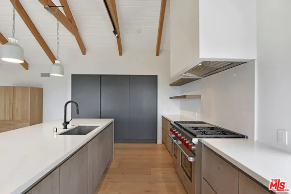 a kitchen with stainless steel appliances a sink a stove and a refrigerator