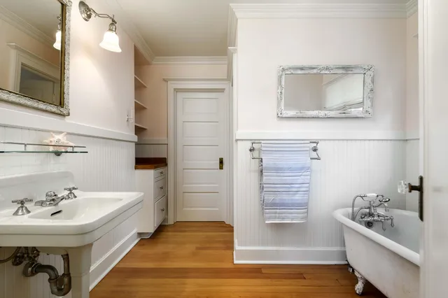 a bathroom with a sink a bathtub and a mirror