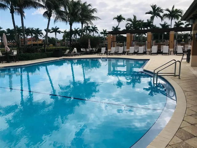 a view of swimming pool with outdoor seating and plants