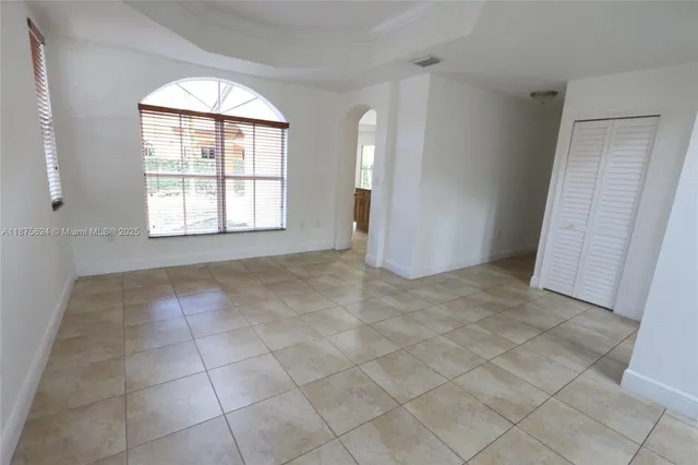 an empty room with windows and closet