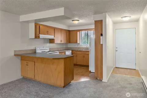 a kitchen with appliances cabinets and a sink